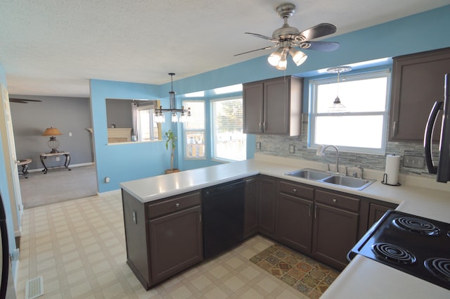 kitchen with sink, dishwasher, kitchen peninsula, backsplash, and hanging light fixtures