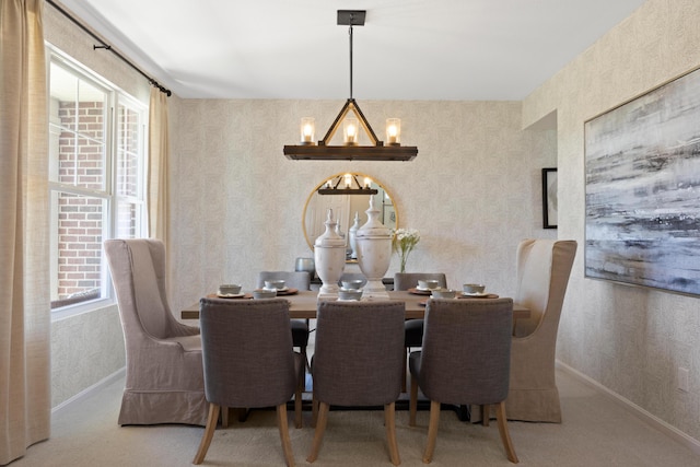 carpeted dining space featuring a notable chandelier