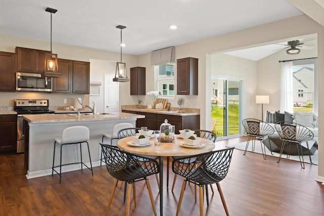 dining room featuring dark hardwood / wood-style floors, ceiling fan, a healthy amount of sunlight, and sink