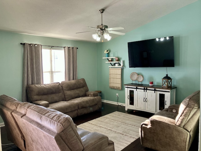 living room featuring a textured ceiling, ceiling fan, hardwood / wood-style floors, and vaulted ceiling