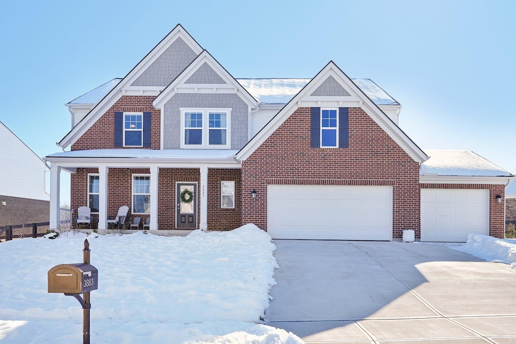 view of front of house featuring covered porch and a garage