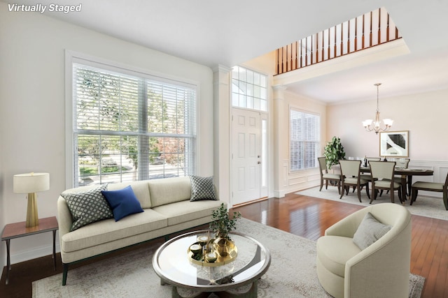 living room with hardwood / wood-style floors and an inviting chandelier