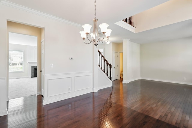 empty room featuring dark hardwood / wood-style flooring and a chandelier