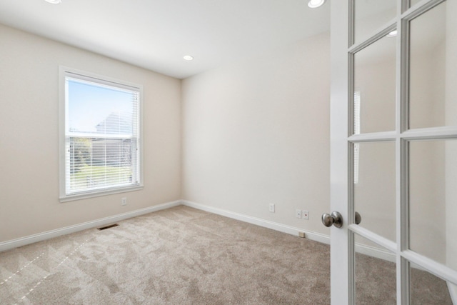 carpeted empty room with french doors