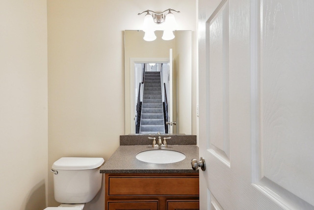 bathroom featuring toilet and vanity