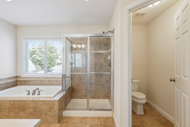 bathroom featuring toilet, tile patterned flooring, and plus walk in shower