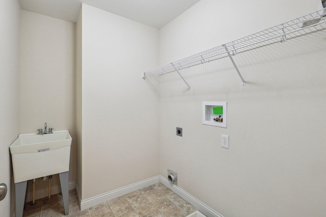 clothes washing area with sink, hookup for an electric dryer, and hookup for a washing machine