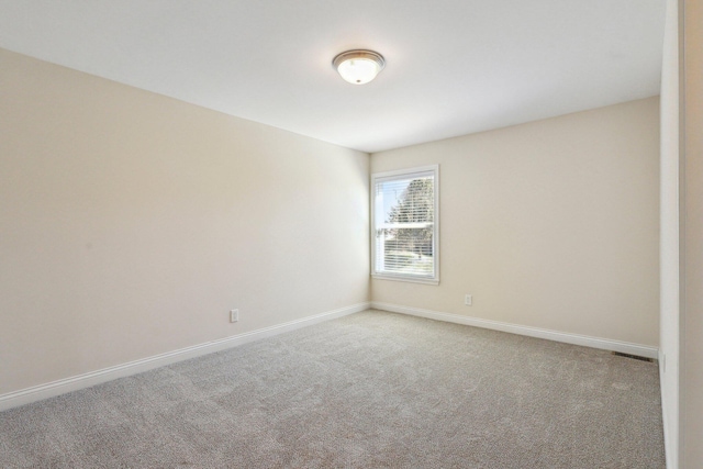 unfurnished room with light carpet