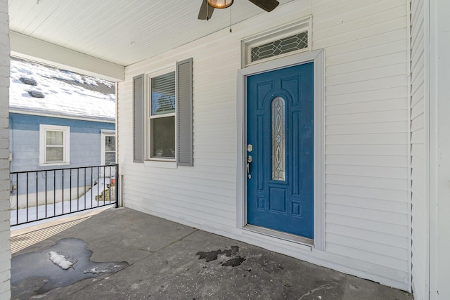 property entrance featuring covered porch and ceiling fan