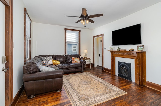 living room with ceiling fan and dark hardwood / wood-style floors