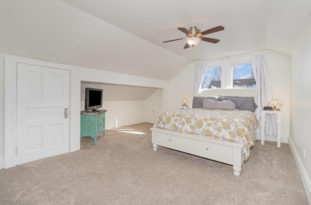 bedroom with lofted ceiling, ceiling fan, and light carpet