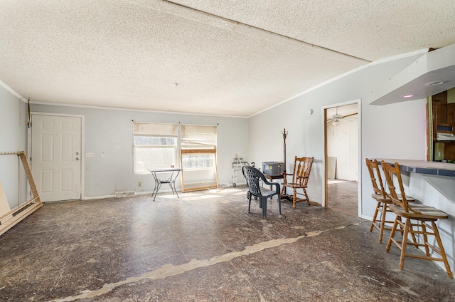 dining space featuring visible vents, a textured ceiling, and crown molding