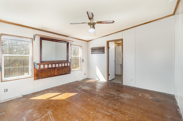 spare room featuring a ceiling fan and ornamental molding