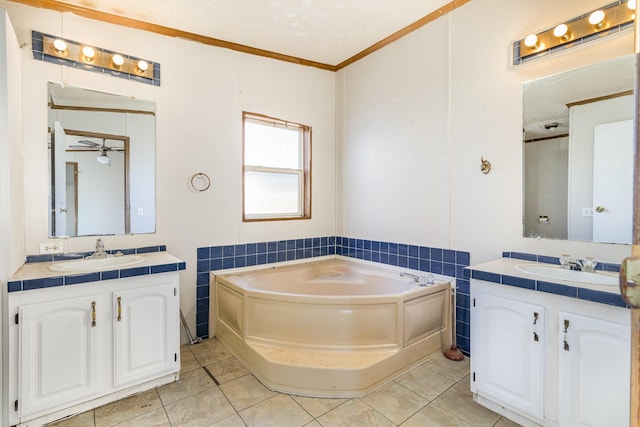 full bathroom with a sink, two vanities, a bath, and tile patterned floors