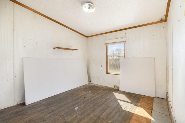 unfurnished room featuring a textured ceiling, crown molding, and hardwood / wood-style flooring