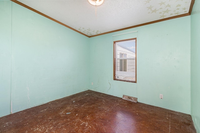 empty room featuring visible vents, a textured ceiling, and crown molding