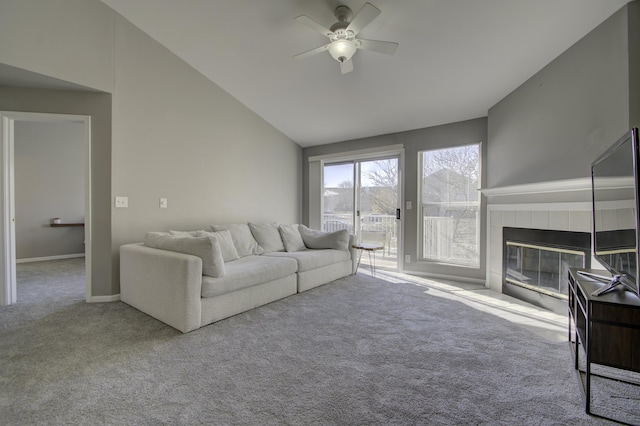 unfurnished living room featuring high vaulted ceiling, a fireplace, light carpet, and ceiling fan