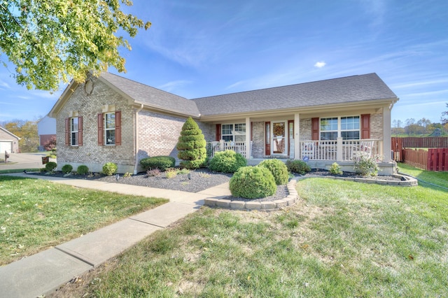 ranch-style house with covered porch and a front yard