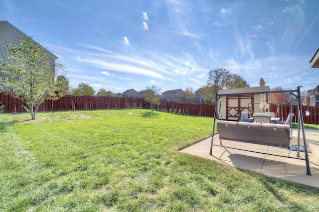 view of yard featuring a shed and a patio