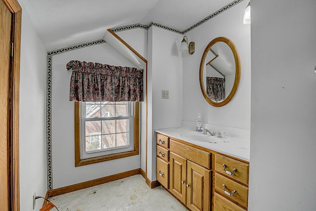 bathroom with concrete floors, vanity, and vaulted ceiling