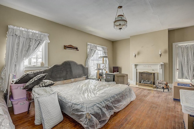 bedroom featuring wood-type flooring and multiple windows