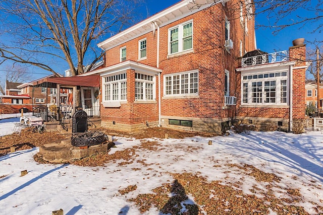 snow covered property with cooling unit