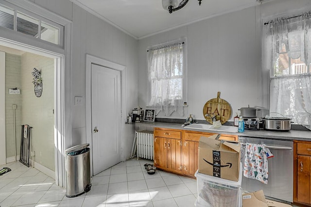 kitchen with radiator, light tile patterned floors, crown molding, and stainless steel dishwasher