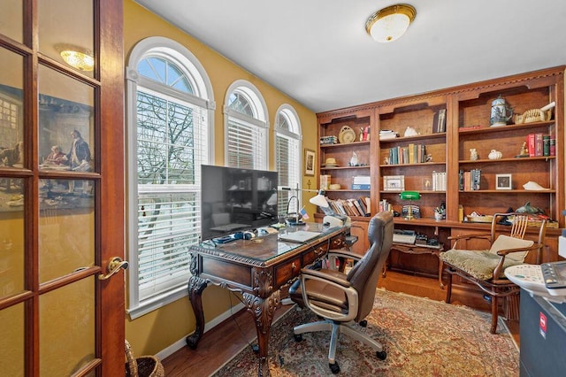 home office with wood-type flooring