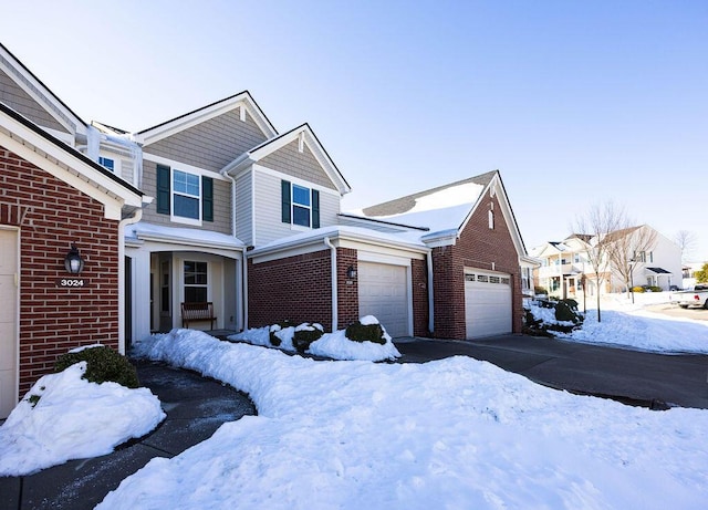 view of snow covered exterior featuring a garage