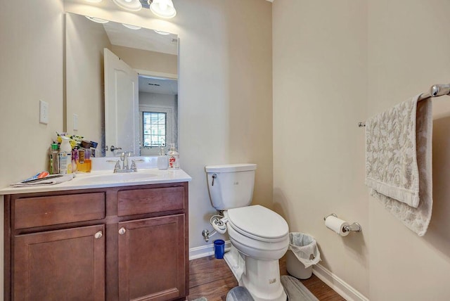 bathroom featuring hardwood / wood-style floors, toilet, and vanity