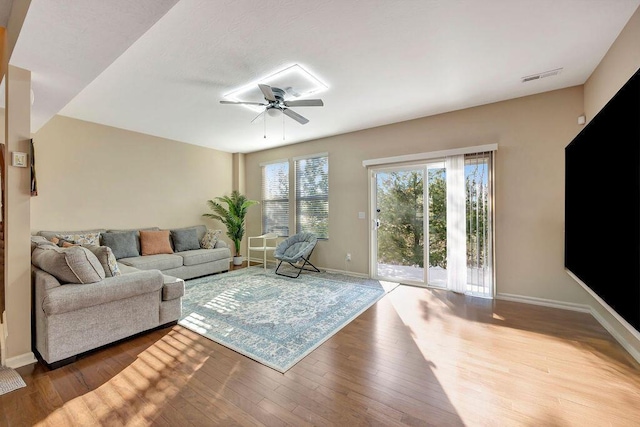 living room featuring ceiling fan and wood-type flooring