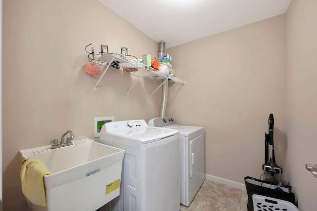 washroom featuring separate washer and dryer and sink