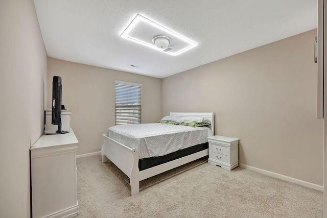 carpeted bedroom featuring a textured ceiling