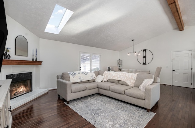 living room with a textured ceiling, lofted ceiling with beams, and dark hardwood / wood-style floors