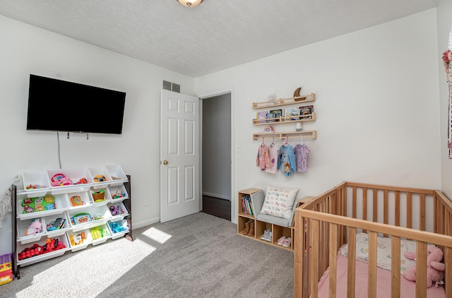 bedroom featuring a nursery area and carpet flooring