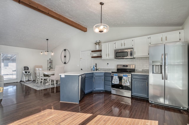 kitchen with decorative light fixtures, tasteful backsplash, white cabinets, and appliances with stainless steel finishes