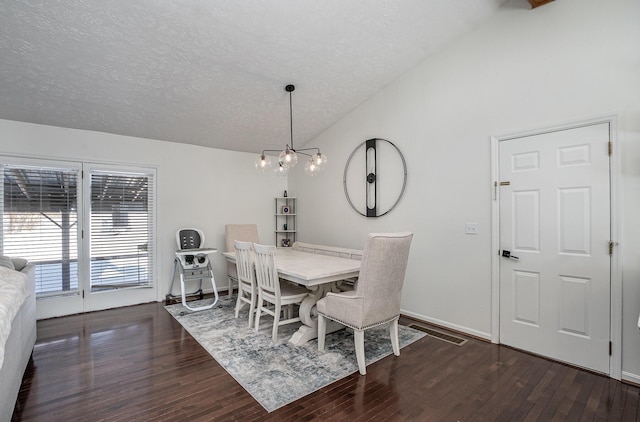 dining area with lofted ceiling, an inviting chandelier, a textured ceiling, and dark hardwood / wood-style floors