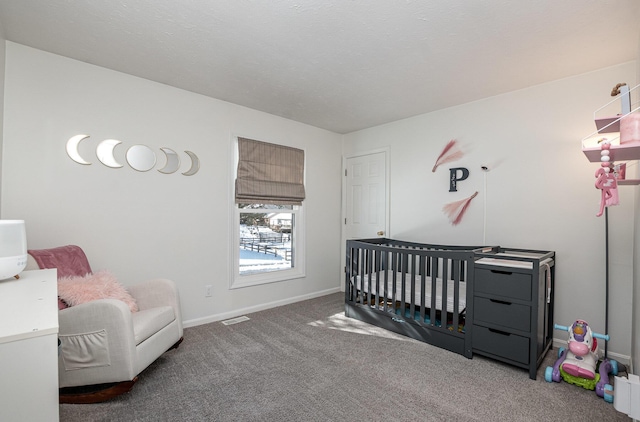 carpeted bedroom featuring a nursery area