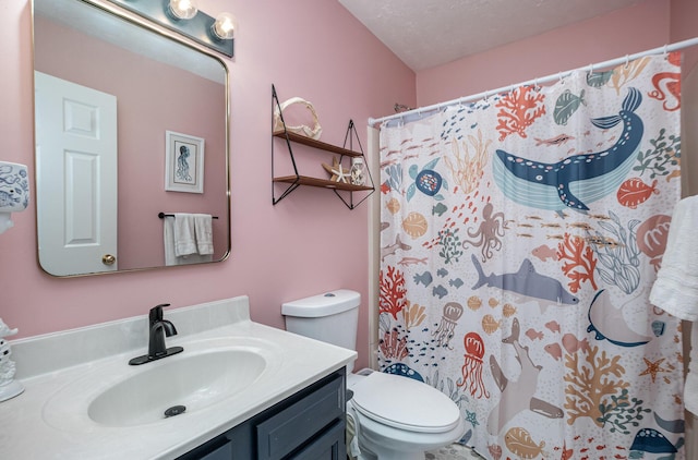 bathroom with a textured ceiling, a shower with curtain, vanity, and toilet