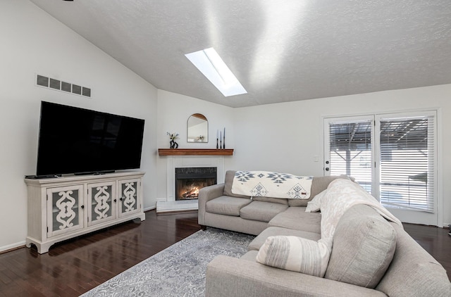 living room featuring lofted ceiling, a textured ceiling, and hardwood / wood-style floors