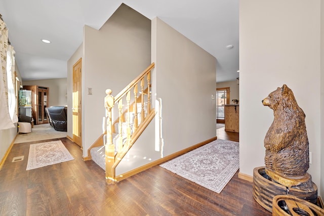 foyer entrance featuring vaulted ceiling and hardwood / wood-style floors