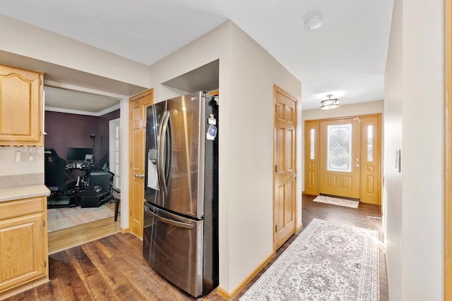 kitchen featuring stainless steel refrigerator with ice dispenser, dark wood-type flooring, and light brown cabinetry