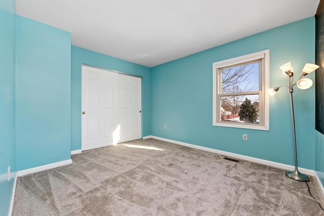 unfurnished bedroom featuring a closet and carpet