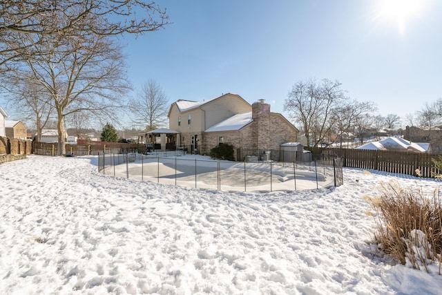 snow covered house with a gazebo