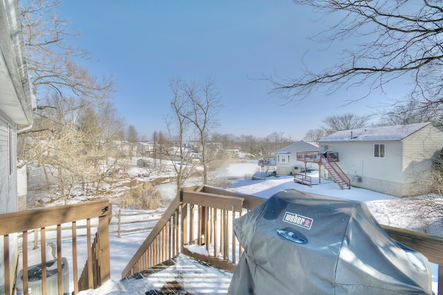 snow covered deck featuring area for grilling and central air condition unit