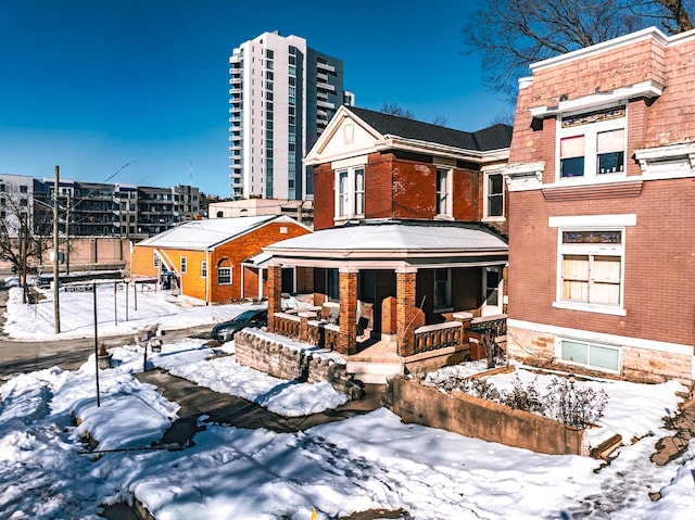 view of snow covered rear of property