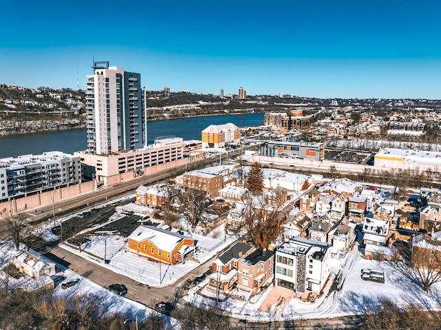 snowy aerial view featuring a water view