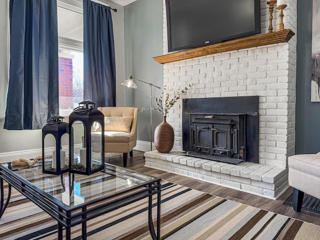 sitting room with dark hardwood / wood-style flooring and a wood stove