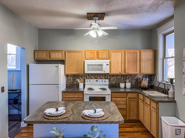 kitchen with sink, a textured ceiling, white appliances, backsplash, and dark hardwood / wood-style flooring