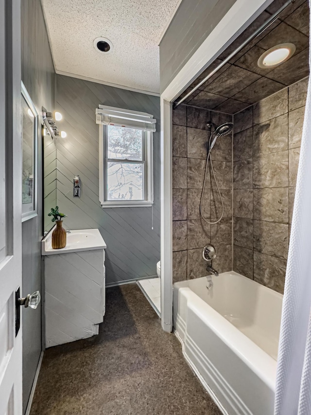 full bathroom with toilet, a textured ceiling, wood walls, shower / bathtub combination with curtain, and vanity